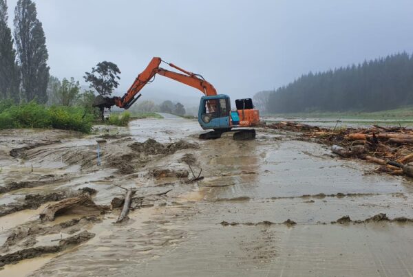 Sumitomo with people attaching heavy-duty MightyGrip track attachments